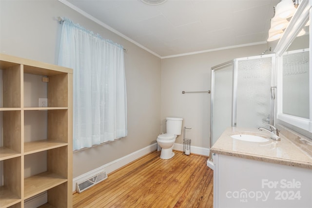 bathroom with hardwood / wood-style floors, vanity, toilet, and crown molding