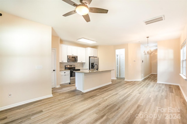 kitchen with a kitchen island with sink, light hardwood / wood-style flooring, white cabinets, and stainless steel appliances