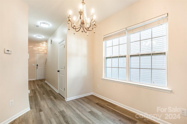 9036 Bradstreet Commons Way, Charlotte, NC 28215 - unfurnished dining area featuring a chandelier, wood finished floors, and baseboards