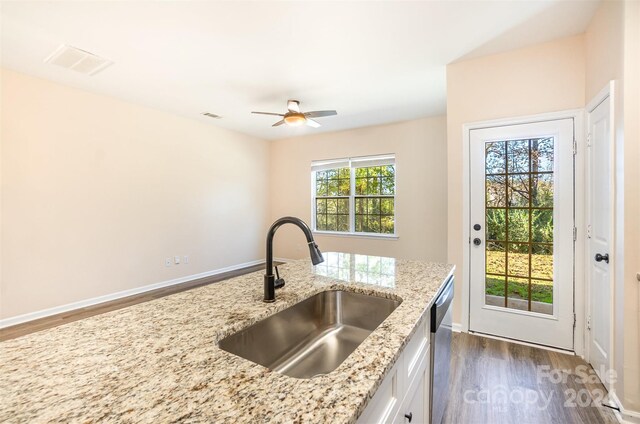 9036 Bradstreet Commons Way, Charlotte, NC 28215 - kitchen featuring a sink, dark wood finished floors, white cabinets, ceiling fan, and light stone counters