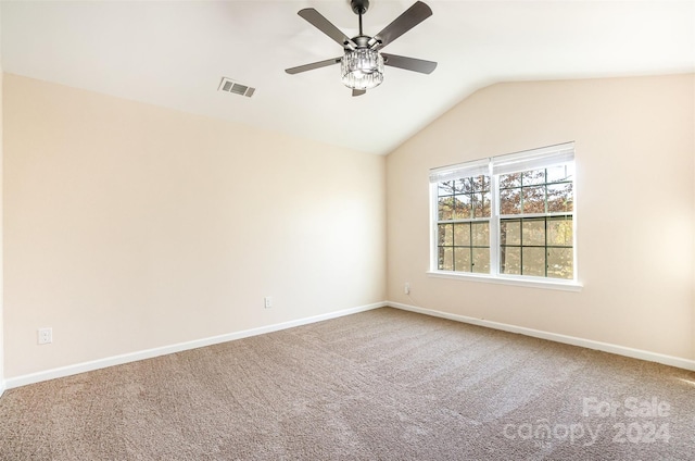 carpeted empty room featuring ceiling fan and vaulted ceiling