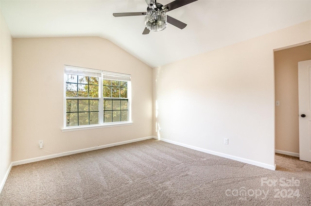 spare room featuring ceiling fan, carpet, and lofted ceiling