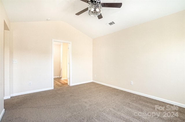 unfurnished room featuring ceiling fan, carpet, and lofted ceiling