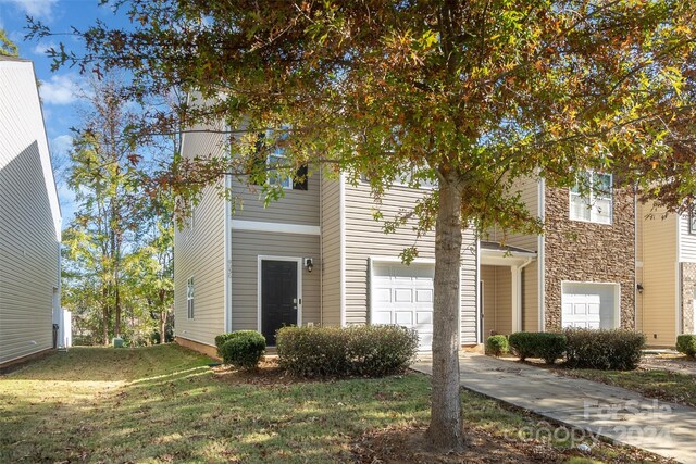 9036 Bradstreet Commons Way, Charlotte, NC 28215 - view of front of property with a garage, concrete driveway, a front yard, and stone siding