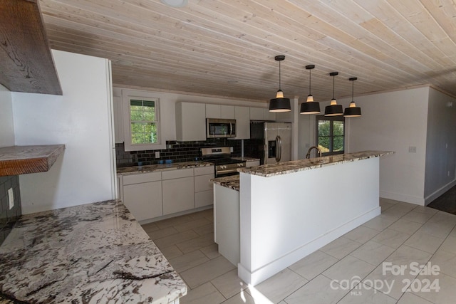 kitchen with a center island with sink, plenty of natural light, white cabinetry, and stainless steel appliances