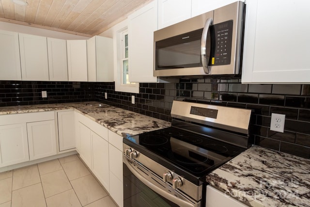 kitchen featuring light stone countertops, appliances with stainless steel finishes, tasteful backsplash, wooden ceiling, and white cabinets