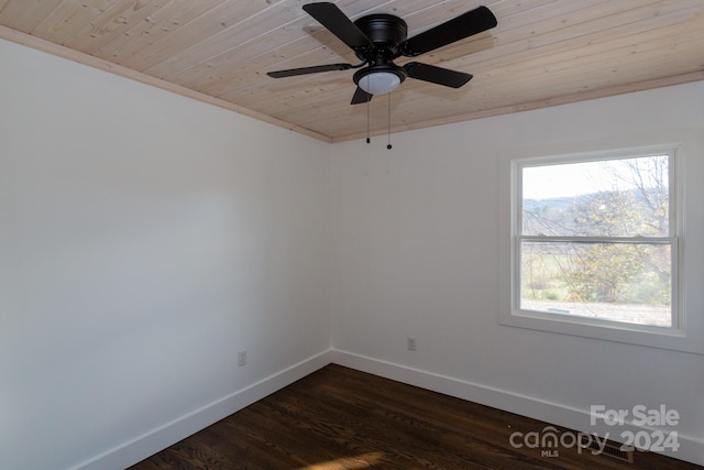 spare room featuring dark wood-type flooring, crown molding, ceiling fan, and wooden ceiling