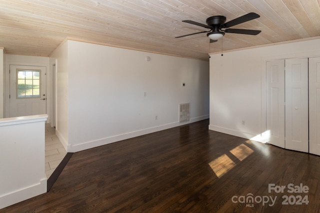 interior space featuring dark hardwood / wood-style flooring, ceiling fan, ornamental molding, and wood ceiling