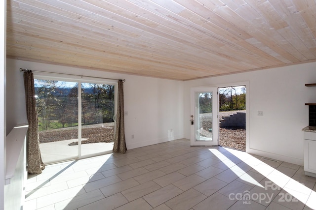 unfurnished room with wooden ceiling and light tile patterned floors