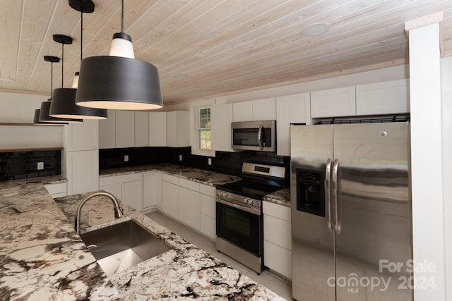 kitchen featuring white cabinetry, sink, tasteful backsplash, pendant lighting, and appliances with stainless steel finishes