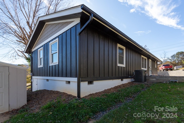 view of home's exterior featuring central air condition unit and a shed