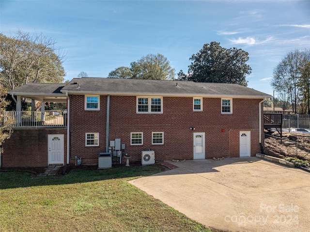 rear view of property with a patio area, a yard, and central AC unit