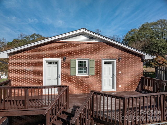 back of house featuring a wooden deck