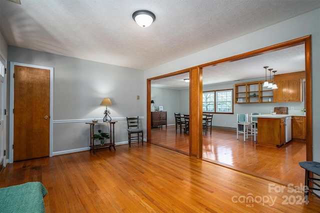 interior space featuring a textured ceiling and light wood-type flooring