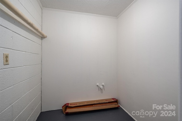 washroom with crown molding and a textured ceiling