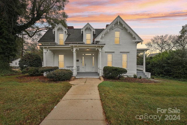 view of front of home with a lawn and covered porch