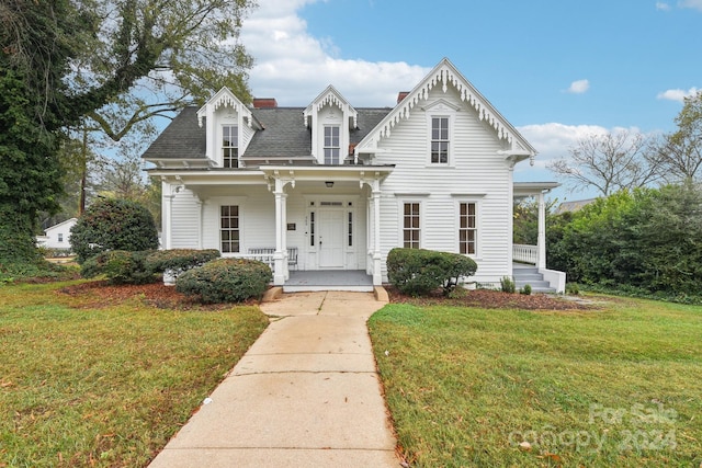 view of front of house with covered porch and a front yard