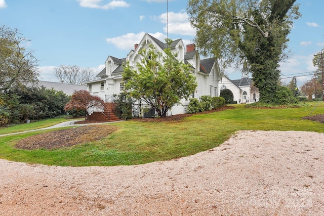 view of property exterior with a lawn