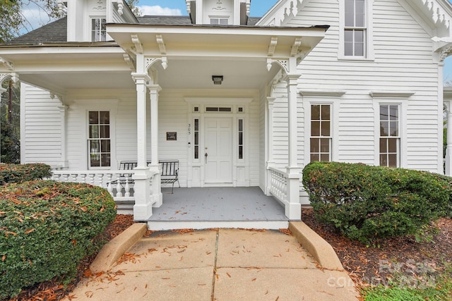 view of exterior entry featuring a porch