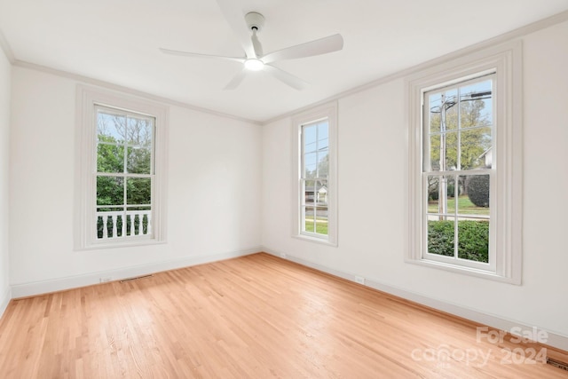 empty room with light hardwood / wood-style flooring, ceiling fan, and ornamental molding