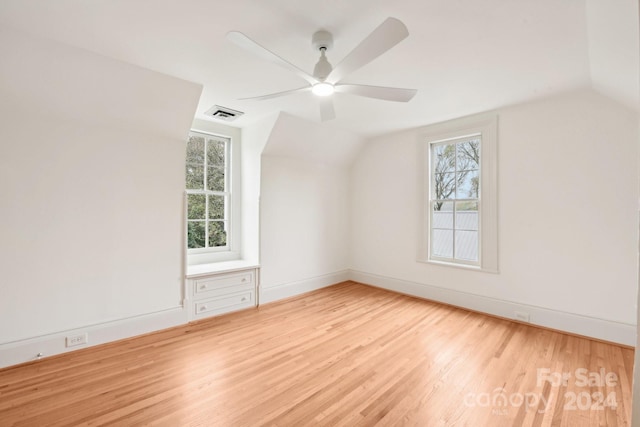 bonus room featuring lofted ceiling, a wealth of natural light, and light hardwood / wood-style flooring