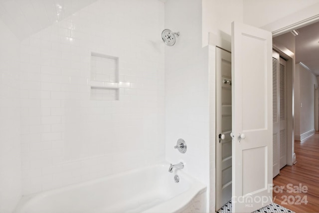 bathroom featuring hardwood / wood-style flooring and tiled shower / bath combo