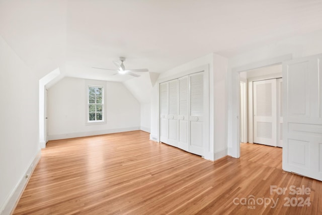 additional living space featuring ceiling fan, light hardwood / wood-style floors, and vaulted ceiling