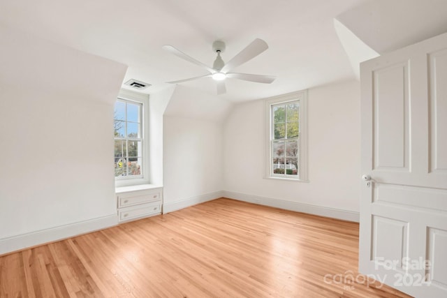 bonus room featuring ceiling fan, a healthy amount of sunlight, vaulted ceiling, and light hardwood / wood-style flooring