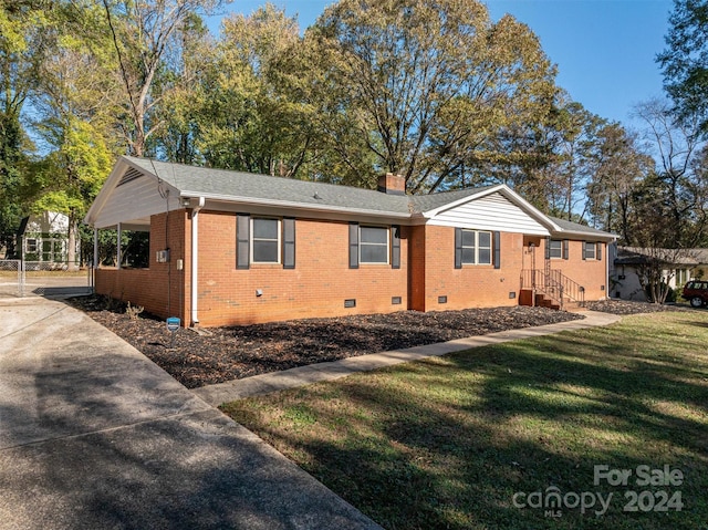 view of side of property featuring a yard and a carport