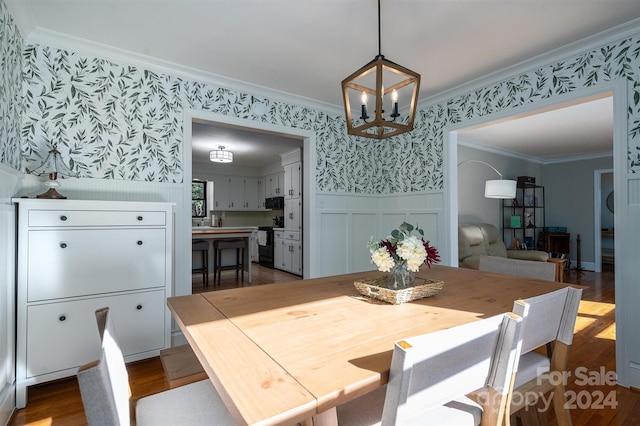 dining space with a chandelier, dark hardwood / wood-style floors, and ornamental molding