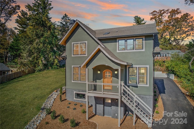 view of front facade featuring a lawn and covered porch