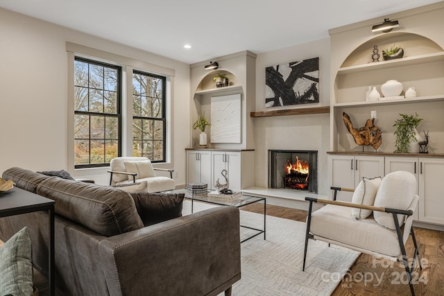 living room with light hardwood / wood-style flooring and built in features