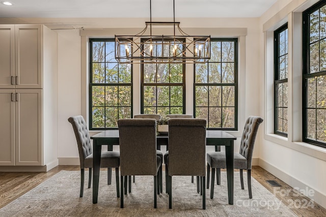 dining room featuring a notable chandelier and light wood-type flooring