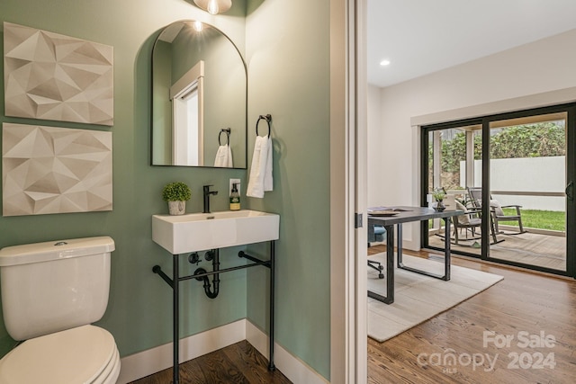 bathroom featuring sink, toilet, and hardwood / wood-style flooring