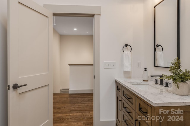 bathroom with hardwood / wood-style floors and vanity