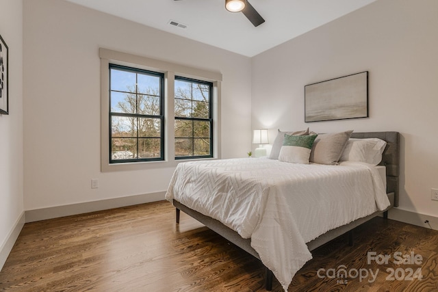 bedroom with ceiling fan and wood-type flooring