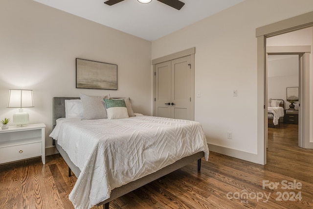 bedroom with a closet, dark hardwood / wood-style floors, and ceiling fan