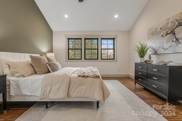 bedroom with dark hardwood / wood-style flooring and vaulted ceiling