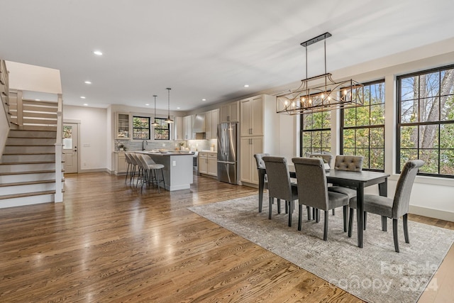 dining area with dark hardwood / wood-style flooring and a notable chandelier