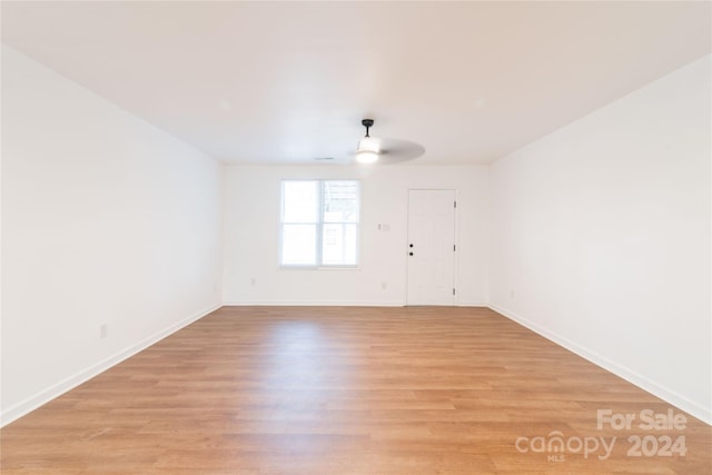 unfurnished room with ceiling fan and light wood-type flooring