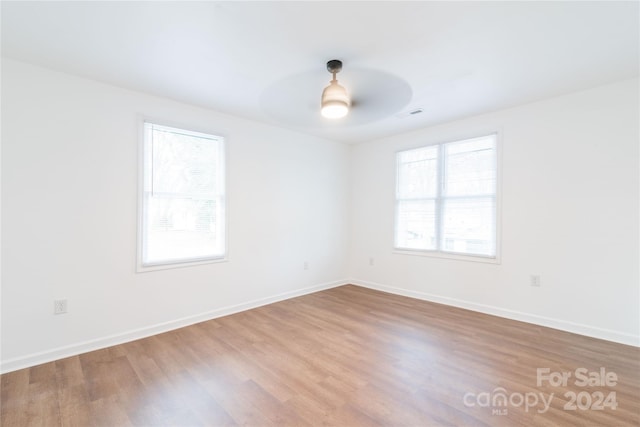 spare room with ceiling fan and wood-type flooring