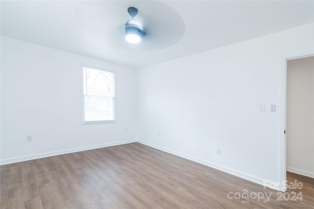 empty room featuring ceiling fan and light hardwood / wood-style floors