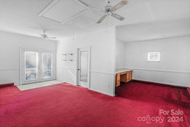 additional living space with carpet floors, a wealth of natural light, and ceiling fan