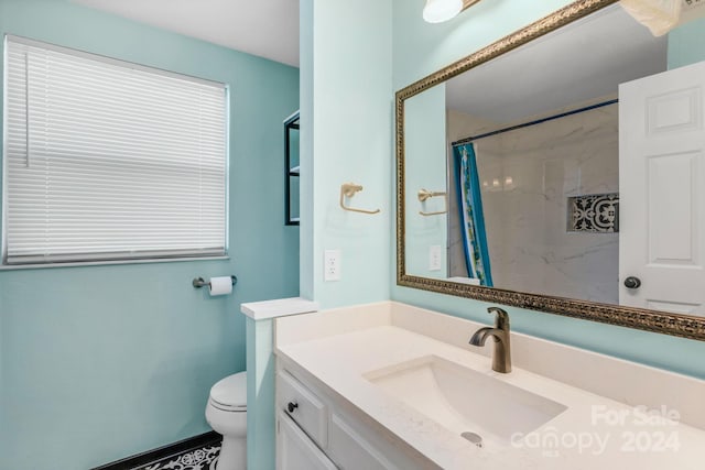 bathroom with vanity, curtained shower, and toilet