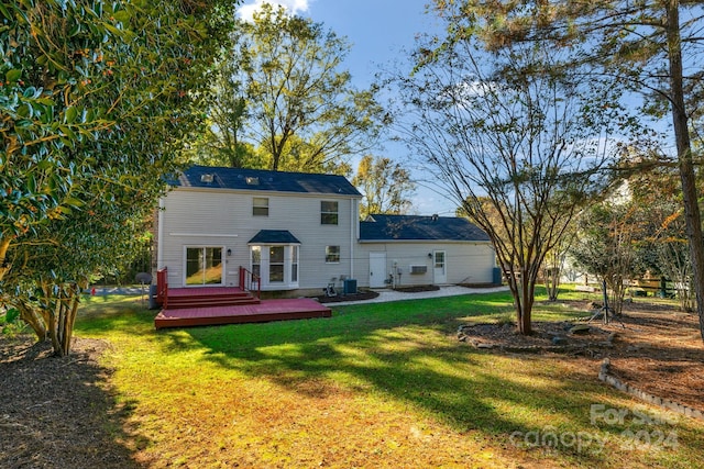 back of house with a lawn, central AC unit, and a wooden deck