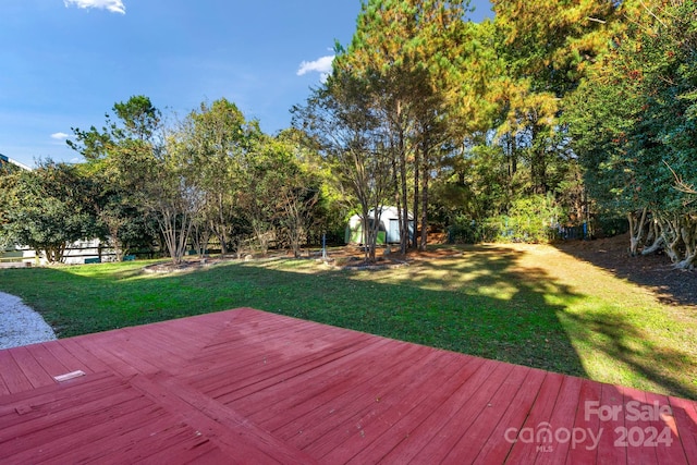 wooden terrace with a yard