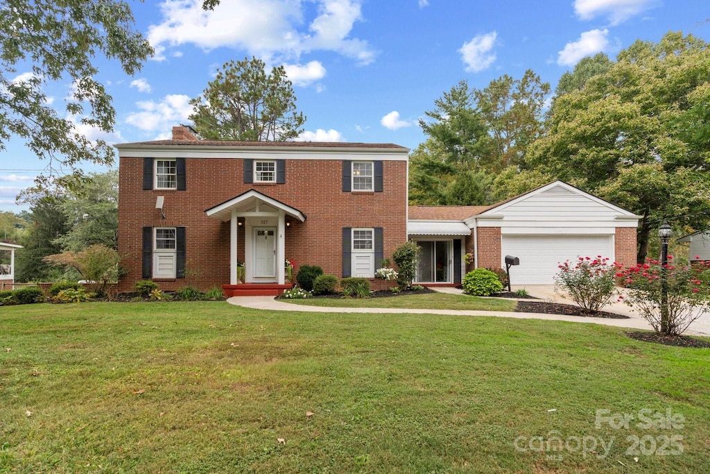 view of front of house with a front lawn and a garage