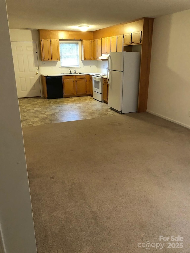 kitchen with white appliances, light colored carpet, light countertops, under cabinet range hood, and a sink