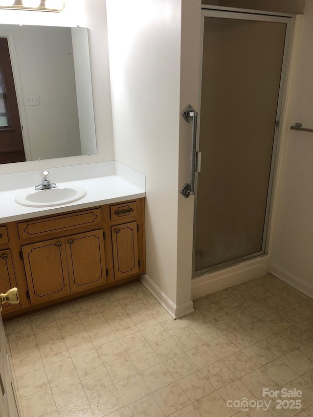 full bathroom featuring a stall shower and vanity