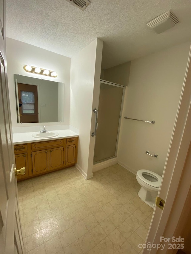 bathroom with visible vents, a shower stall, vanity, and tile patterned floors